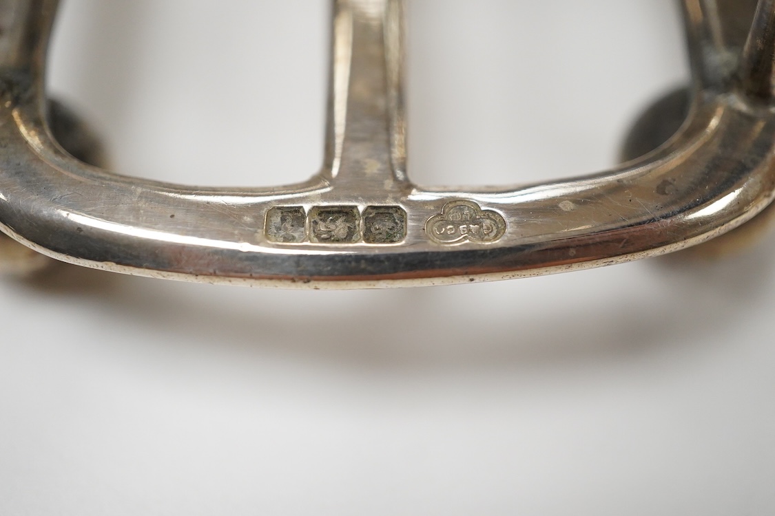 An Edwardian silver mug, on claw and hoof feet, William Hutton & Sons, London 1909, height 83mm, together with a silver butter shell, mustard pot and a silver five bar toastrack, 17oz.